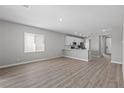 Open concept living and kitchen area features hardwood floors, neutral paint and recessed lighting at 4421 Pioche Ave, North Las Vegas, NV 89032