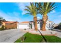 Charming single-story home boasts desert landscaping, two palm trees, and a two-car garage at 5417 Bible Cir, North Las Vegas, NV 89031