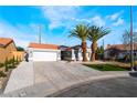 Charming single-story home with tile roof and a well-manicured front yard with mature palm trees at 5417 Bible Cir, North Las Vegas, NV 89031