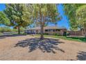 Attractive single-story residence with desert landscaping, mature trees, and a beautifully kept front yard at 5755 W Meranto Ave, Las Vegas, NV 89139