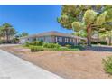 Well-maintained single-story home with desert landscaping, a charming front yard, and a detached garage at 5755 W Meranto Ave, Las Vegas, NV 89139