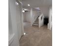 Bright hallway with tile flooring, staircase and access to other areas of the home at 577 Leap Frog Ave, Las Vegas, NV 89183