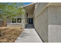 Stylish home entrance with a walkway and attractive landscaping at 6815 Garden Grove Ave, Las Vegas, NV 89103