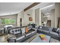 Spacious living room with comfortable leather sofas and an adjacent dining area at 6815 Garden Grove Ave, Las Vegas, NV 89103