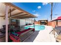 Inviting backyard featuring a private pool, lounge swing, and gazebo with a hot tub at 704 N Wallace Dr, Las Vegas, NV 89107
