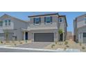Charming two-story home with a gray exterior, well-manicured landscaping, and a two-car garage at 7086 Parkallen Ave, Las Vegas, NV 89113