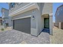 A close up of the home showcasing the garage, entryway, and well-maintained landscaping at 7086 Parkallen Ave, Las Vegas, NV 89113