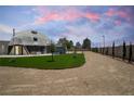 Exterior view of the dome-shaped home with a well-maintained yard and long driveway at 7215 Ullom Dr, Las Vegas, NV 89118