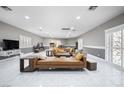 Spacious living room with tile floors, recessed lighting, and modern furnishings at 7215 Ullom Dr, Las Vegas, NV 89118