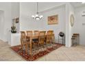 Elegant dining room featuring a classic chandelier and seating for eight, perfect for gatherings at 8021 Glacier Falls St, North Las Vegas, NV 89085