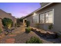 Cozy backyard with gravel, stone pavers, and view to the home's windows at 816 Stannard Ct, Henderson, NV 89052