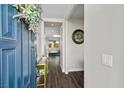 Inviting entryway showcasing a striking blue front door and views into the modern living space with hardwood floors at 8353 Lower Trailhead Ave, Las Vegas, NV 89113