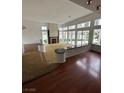 Bright living room features dark wood flooring, a fireplace, and many windows for lots of natural light at 8761 Rainbow Ridge Dr, Las Vegas, NV 89117