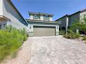 Two-story home features a wide driveway, two-car garage, and simple landscaping for great curb appeal at 9348 Wildcat Peak St, Las Vegas, NV 89178