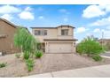 Inviting two-story home with a well-maintained front yard and brick driveway at 1631 Desert Path Ave, North Las Vegas, NV 89032