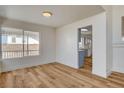 Dining room boasts wood-look floors, recessed lighting, and large windows offering backyard views and abundant natural light at 1716 Klamath Falls Way, Las Vegas, NV 89128