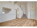 Bright foyer with soaring ceilings, wood-look flooring, and staircase; the neutral palette provides a modern, airy feel at 1716 Klamath Falls Way, Las Vegas, NV 89128