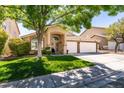 Charming home with a well-maintained lawn and a three-car garage at 1779 Antelope Valley Ave, Henderson, NV 89012