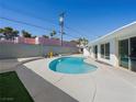 Private kidney-shaped pool surrounded by concrete patio and artificial turf offers a refreshing outdoor oasis at 2245 Sombrero Dr, Las Vegas, NV 89169