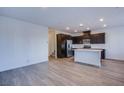 Open floor plan showcasing kitchen with quartz island and stainless steel appliances at 31 Newport Edge Pl, Henderson, NV 89015