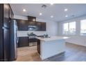 Bright kitchen with stainless steel appliances and island providing ample counter space at 31 Newport Edge Pl, Henderson, NV 89015