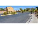Community entrance featuring a secure gate, landscaping, and well-maintained street at 3429 Glacial Lake St, Las Vegas, NV 89122