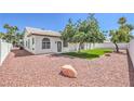 Spacious backyard featuring desert landscaping with an ample artificial lawn at 3693 Miguels Ln, Las Vegas, NV 89120