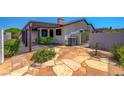 Cozy backyard featuring a covered patio and a stone-paved area, ideal for outdoor relaxation at 454 Intrepid Ct, Boulder City, NV 89005