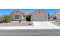 Charming single-story home with desert landscaping and a two-car garage at 4724 Victoria Beach Way, Las Vegas, NV 89130