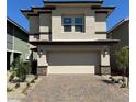 Modern two-story home with a two-car garage, neutral paint, and stone accents at 514 Red Lovebird Ave # Lot 1241, Henderson, NV 89011