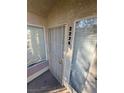 Close-up of unit entrance with secure door and bright natural light from nearby windows at 5710 E Tropicana Ave # 2225, Las Vegas, NV 89122