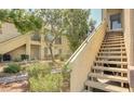 Charming condo exterior featuring well-maintained landscaping and inviting staircase at 5710 E Tropicana Ave # 2225, Las Vegas, NV 89122