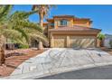 Charming two-story home with a tile roof, an attached two-car garage, and a well-manicured lawn at 5805 Cabo San Lucas Ave, Las Vegas, NV 89131