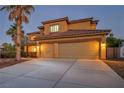 Attractive two-story home featuring an attached two-car garage and a well-lit driveway at 5805 Cabo San Lucas Ave, Las Vegas, NV 89131
