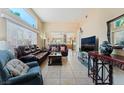 Spacious living room with tile flooring, large windows, and comfortable seating at 5914 Rose Sage St, North Las Vegas, NV 89031