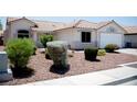 Desert landscaping with gravel and shrubbery complements this single-story home's exterior at 6249 Halehaven Dr, Las Vegas, NV 89110