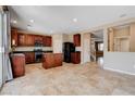 Spacious kitchen with granite countertops, stainless steel appliances, ample cabinet space, tile floor, and open access to other rooms at 6569 Cedar Waxwing St, North Las Vegas, NV 89084
