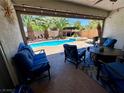 Relaxing backyard with a pool, spa, and comfortable seating on a covered patio, perfect for entertaining at 6614 Collingsworth St, Las Vegas, NV 89131
