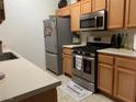 Kitchen featuring stainless steel appliances, light wood cabinets, and a neutral countertop at 700 Carnegie St # 4821, Henderson, NV 89052