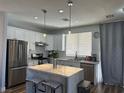 Bright kitchen featuring stainless steel appliances, white cabinetry, and a stylish marble island at 8901 Kingswood Dr, Las Vegas, NV 89147