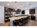Spacious kitchen with a large island, stainless steel appliances, and dark wood cabinetry at 9015 Chopper Prairie St, Las Vegas, NV 89131