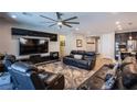 Modern living room featuring a large television, sleek entertainment center, and comfortable leather seating at 9015 Chopper Prairie St, Las Vegas, NV 89131