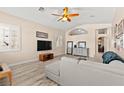 Open-concept living room featuring neutral walls, modern furnishings, and lots of natural light at 9733 Northern Dancer Dr, Las Vegas, NV 89117