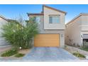 Stylish two-story home with a two-car garage and low-maintenance landscaping at 10347 Restless River St, Las Vegas, NV 89141