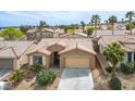 Inviting single-story home featuring a desert landscape, tile roof, and two car garage in a vibrant community at 10513 Shanna Trellis Ave, Las Vegas, NV 89144