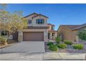 Charming two-story home with a well-manicured front yard and attached two-car garage, perfect for suburban living at 1069 Aspen Cliff Dr, Henderson, NV 89011