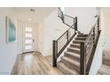 Bright entryway with modern staircase, wood-look floors, and contemporary front door at 12093 Glentana View St, Las Vegas, NV 89138