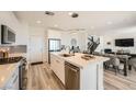 Modern kitchen with white cabinets, stainless appliances, and an island with seating at 12093 Glentana View St, Las Vegas, NV 89138
