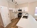 Bright kitchen featuring white cabinets, stainless steel appliances, and a large island at 1333 Pacific Terrace Dr, Las Vegas, NV 89128