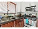 Well-lit kitchen features stainless steel appliances and modern cabinets at 135 Cadrow Castle Ct, Las Vegas, NV 89148